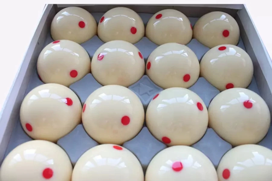 Box of white training balls with red dots in middle