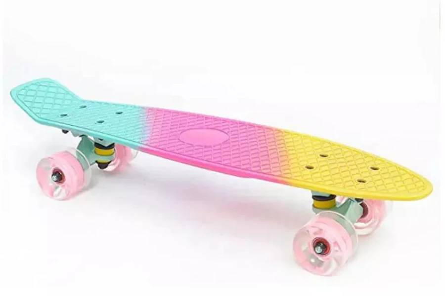 Plastic skateboard with colorful design and pink wheels