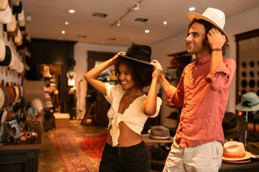 Man and woman trying on cowboy hats