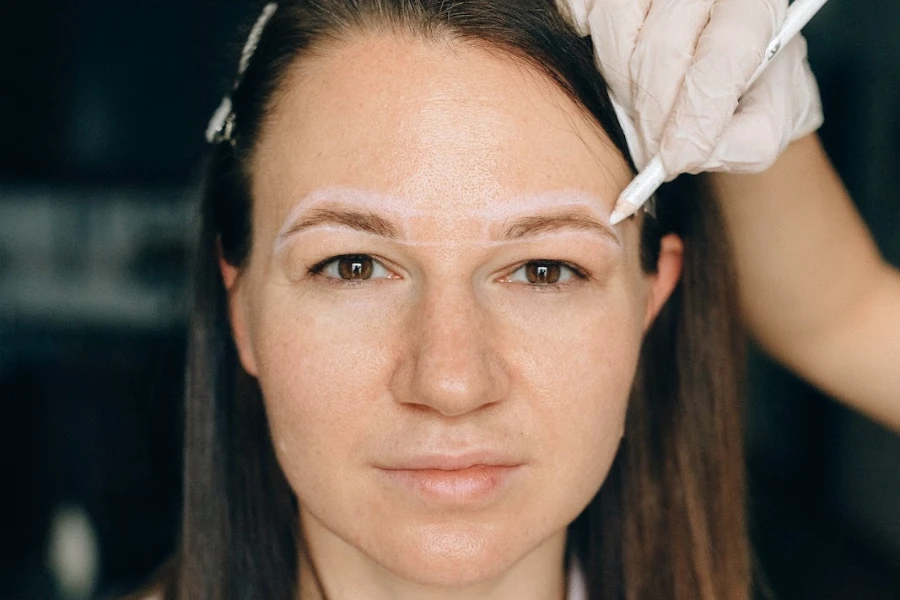 Woman getting eyebrows done professionally