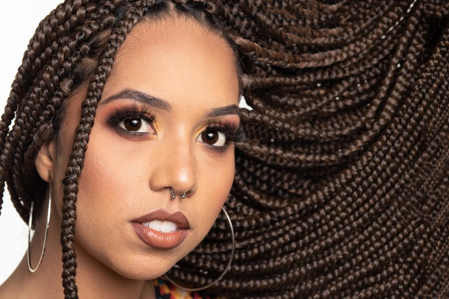 A close-up of a woman with long braided hair