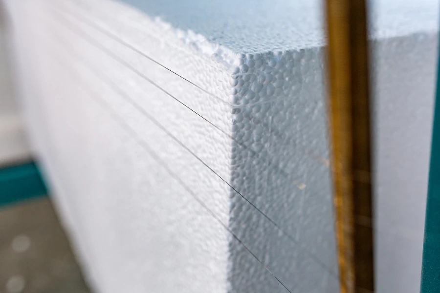 A large block of Styrofoam is cut into plates