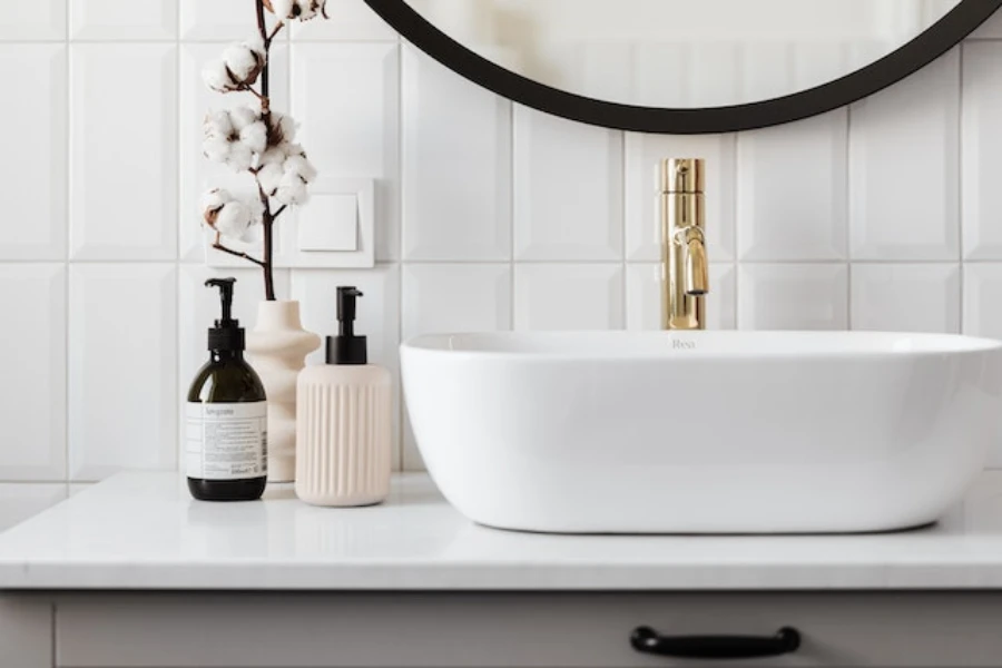 Interior de baño con grifo dorado en un lavabo blanco