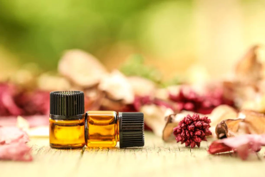 Two tiny bottles with fragrances inside sitting on wooden table