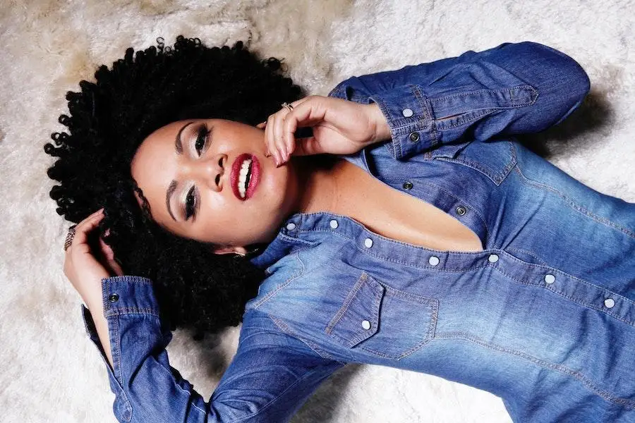 Woman posing with a dark blue denim shirt