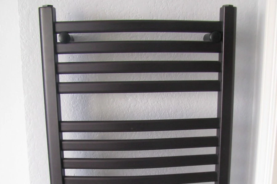 A black copper wall-mounted towel warmer