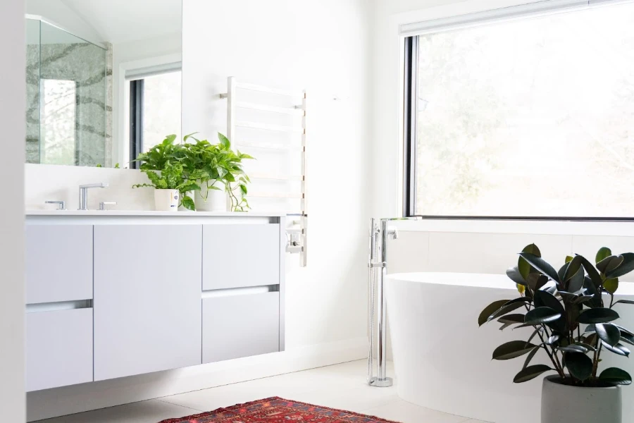 A silver wall-mounted electric towel warmer