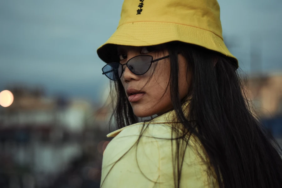 A woman wearing a yellow bucket hat