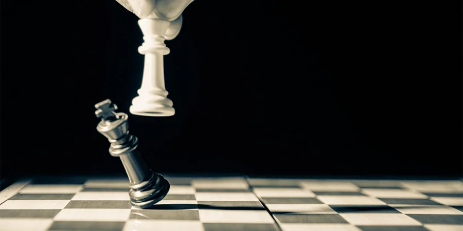 White king taking down black king on a chess board