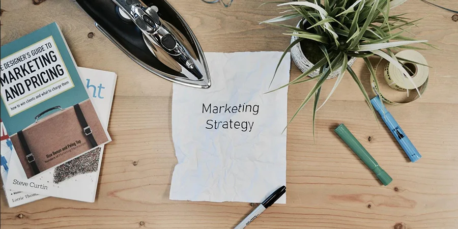 the words ‘marketing strategy’ written on a piece of paper