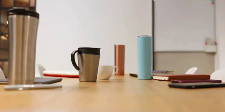 Table with different styles of thermos cups on it