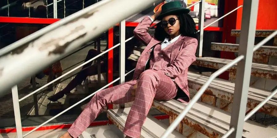 Lady rocking a pink suit and green hat