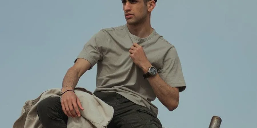 Man rocking trendy pants with grey crew neck shirt