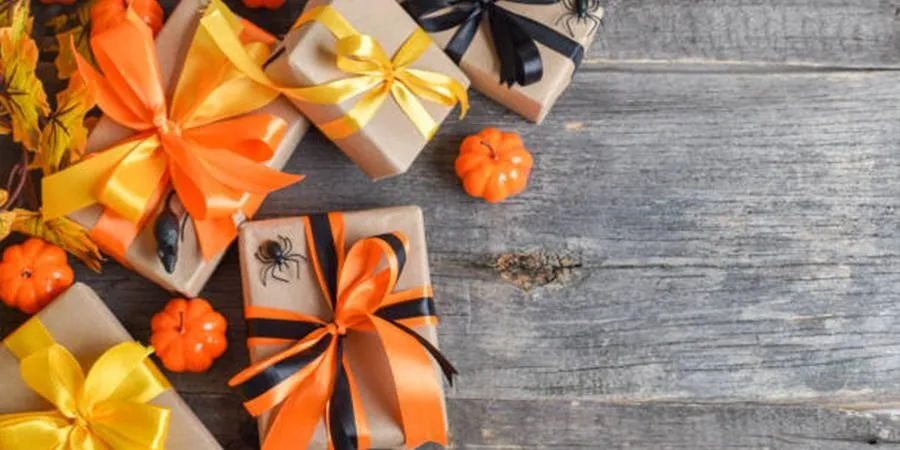 Brown boxes packaged with Halloween-themed ribbons and plastic pumpkins