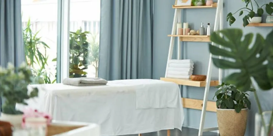 Massage table draped in a white sheet