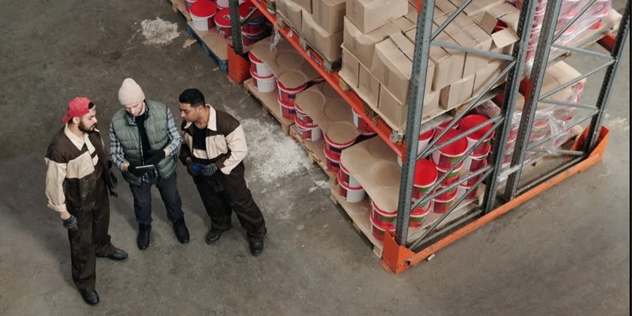 Men taking inventory of the goods in a warehouse