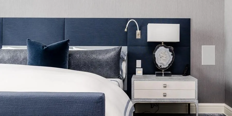 An upholstered bed with blue cushioning