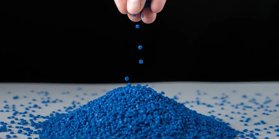 Blue plastic beads on wood background