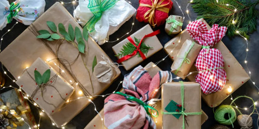 Christmas gifts in boxes and bags with lights on top