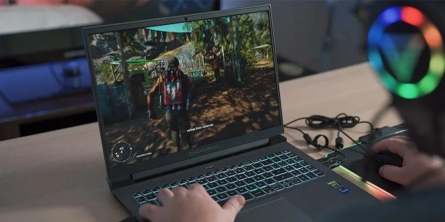 Gamer playing video game on gaming laptop