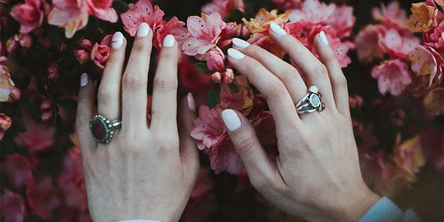 White nail polish on a bouquet of flowers.