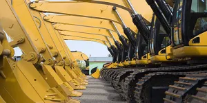 A row of excavators in a parking lot