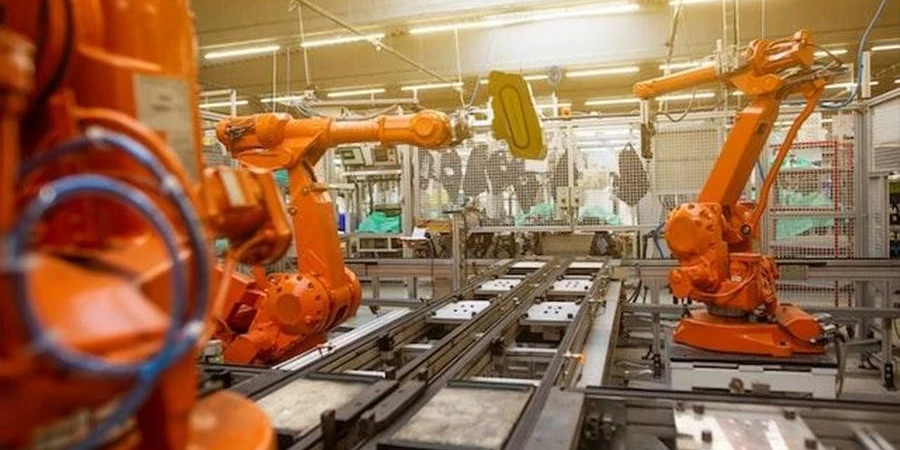 Automated robots in an industrial plant assembling automobiles