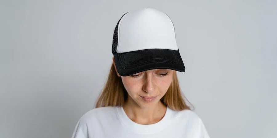 Woman rocking a black and white baseball cap