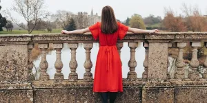 Woman wearing a red dress on a bridge