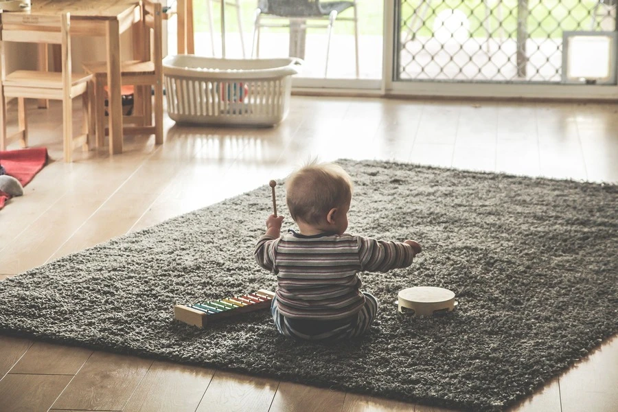 A baby playing with toys on a mat