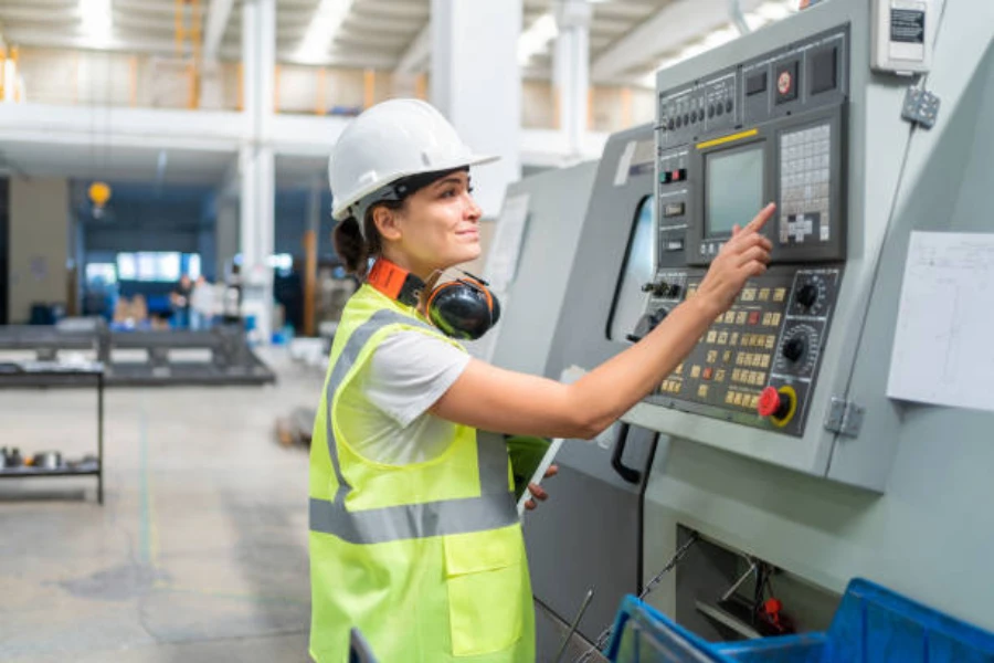 A female engineer programming a CNC machine