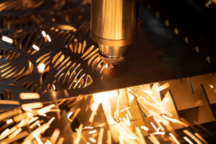 A laser machine engraving holes on a metal sheet