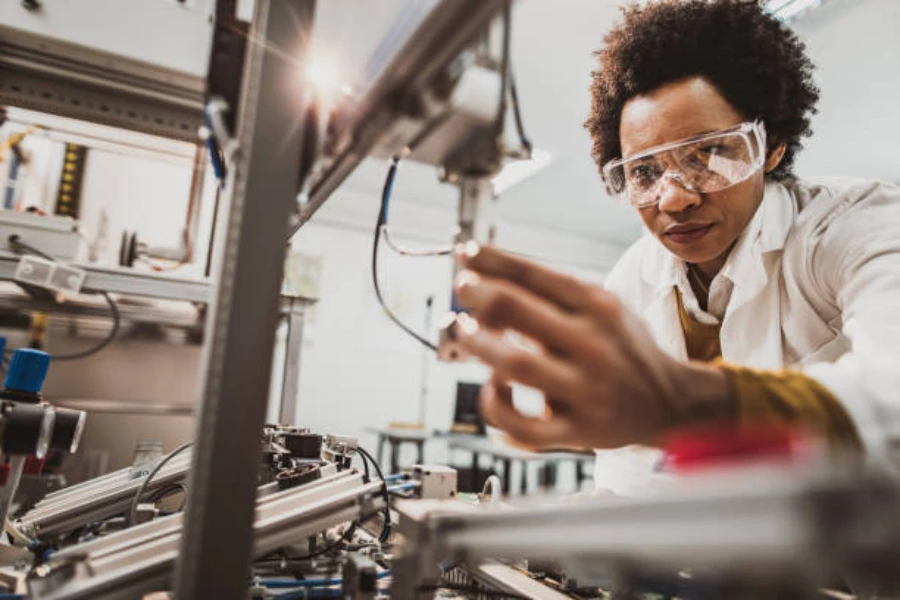 A mechanic examining a machine in a lab