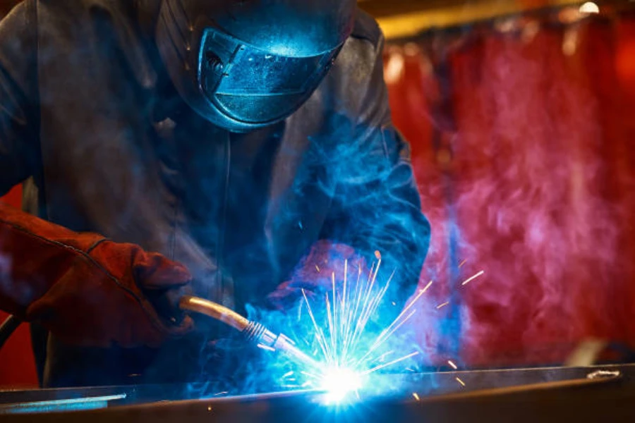 A mechanic using a MIG welding machine