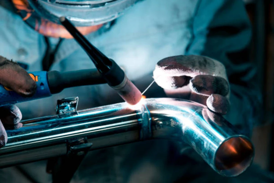 A mechanic using two hands in TIG welding