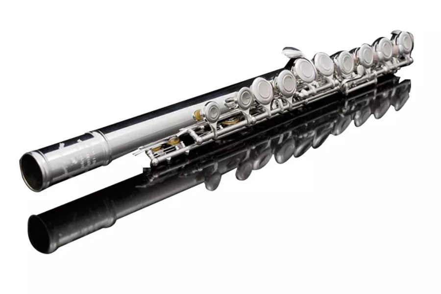 A silver plated flute lying down with white background