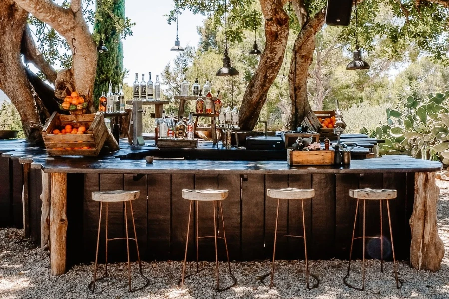 An outdoor kitchen featuring wooden furniture