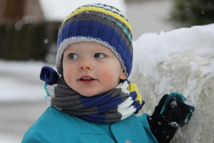 Baby boy in striped knit winter toboggan hat