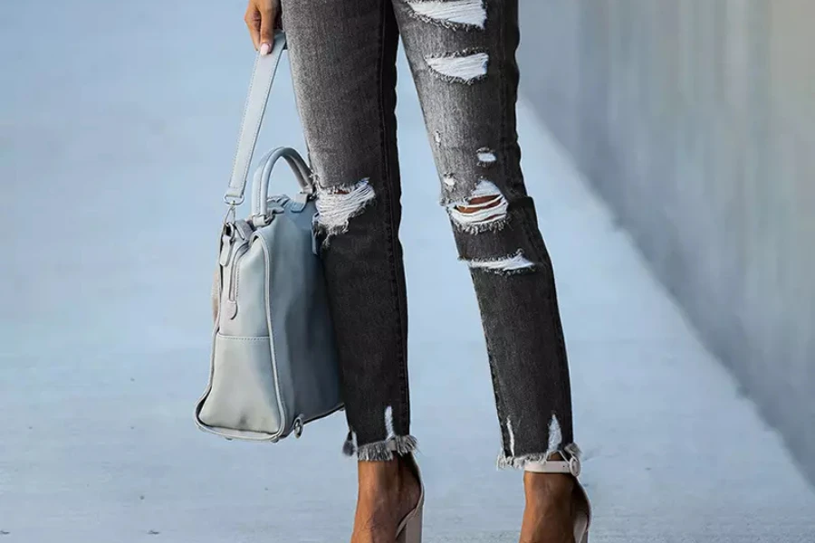 Black ripped jeans with cropped and frayed ankles
