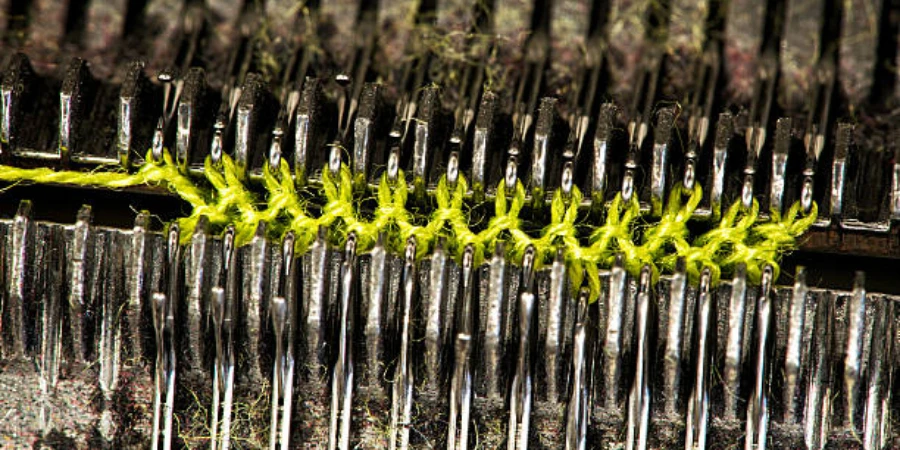 Close-up of green cotton thread on a knitting machine