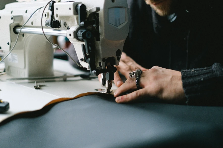 Close-up of tailor sewing on machine