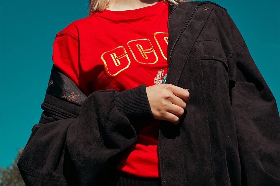 Girl wearing a red 90s grunge top and black jacket