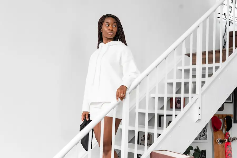 Lady on stairs rocking an all-white ensemble