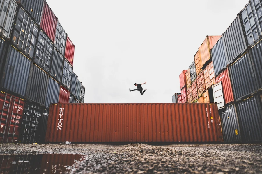 Man jumping on intermodal containers