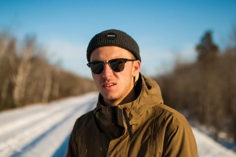 Man wearing black short beanie with logo