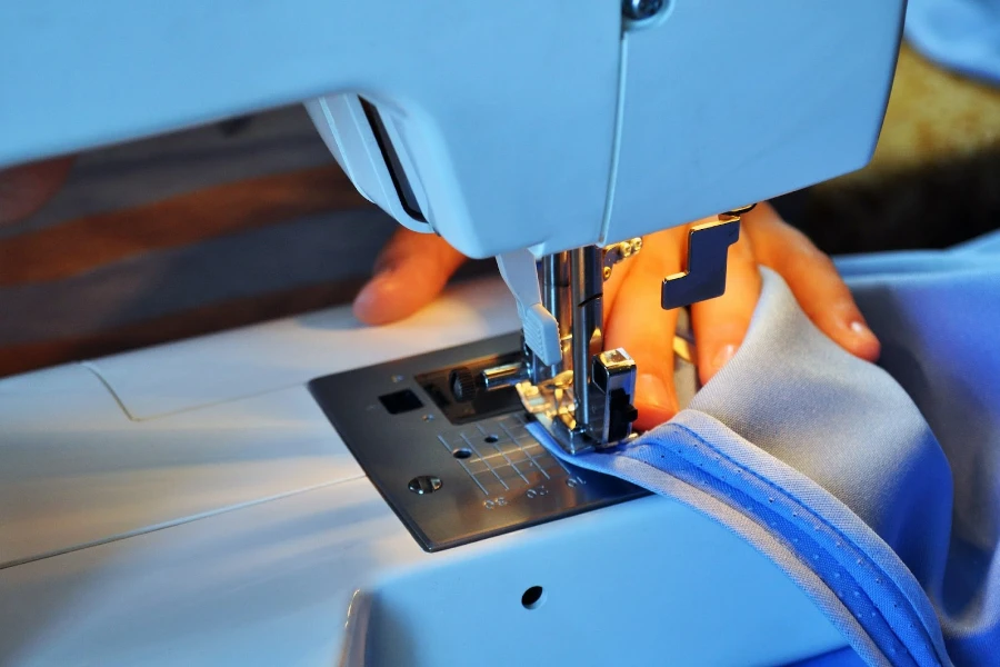 Person sewing using a sewing machine