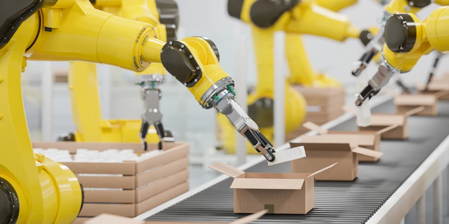 Robotic arms packing cartons in a conveyor belt