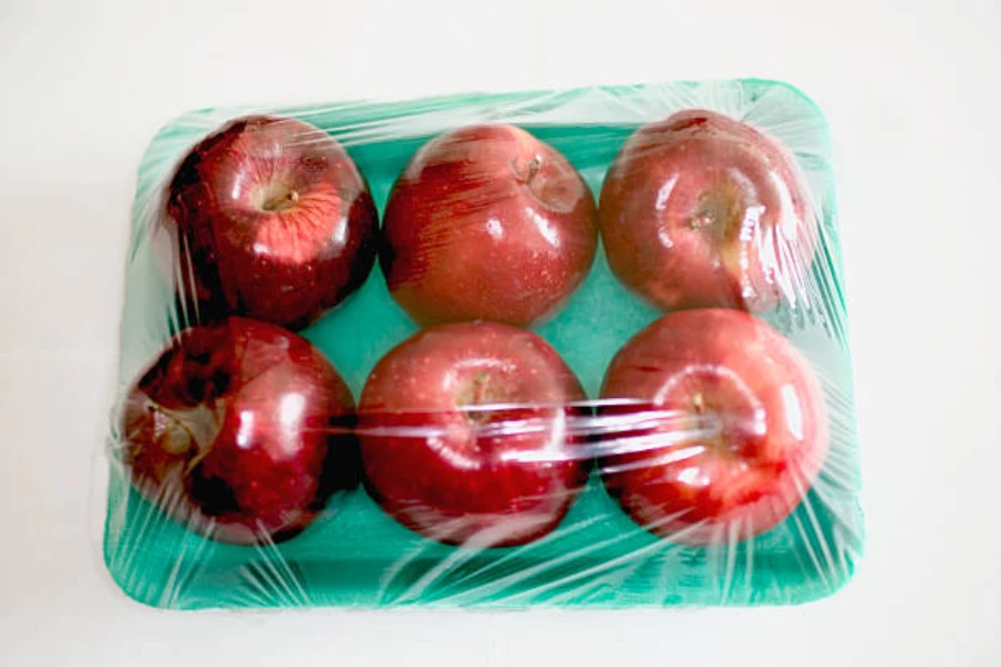Six apples shrink-wrapped with plastic
