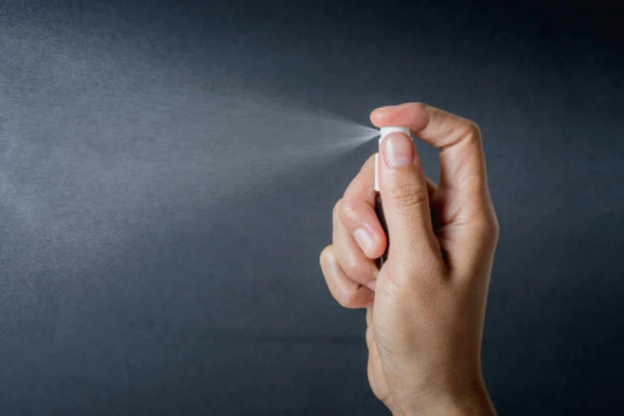 Small portable perfume bottle being sprayed