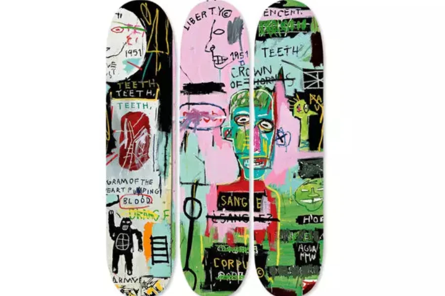 Three skateboards with artistic designs on the bottom